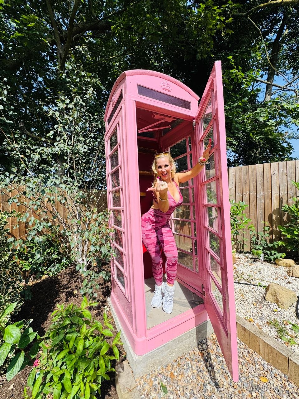 Rebecca More inside the pink phone box in Sophie's Serenity Garden